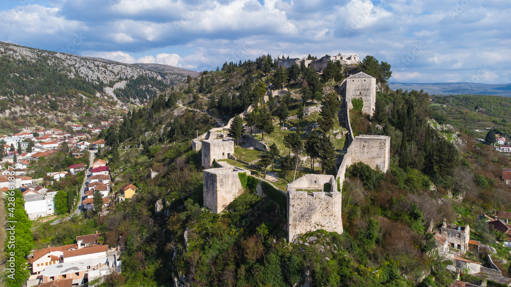 Aerial drone view of historic fortress on the hill. Old castle on a rock.  Old town Vidoski on the hill above city of Stolac, Bosnia and Herzegovina. 