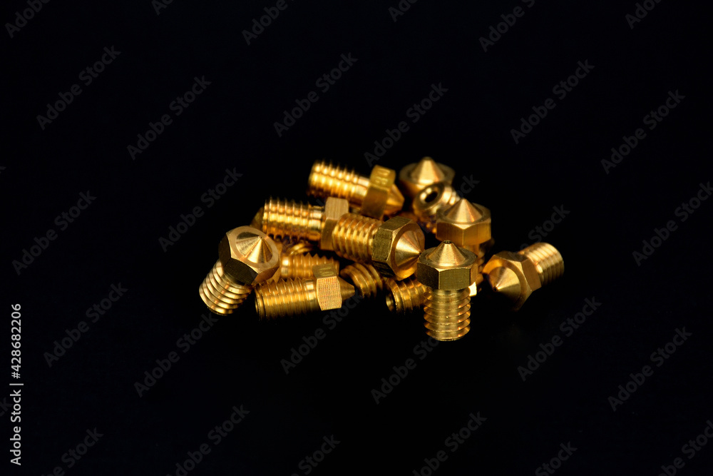 3D printer parts, Brass extrusion nozzles for 3D printing machine on black background 3D printer parts, Brass extrusion nozzles for 3D printing machine on black background