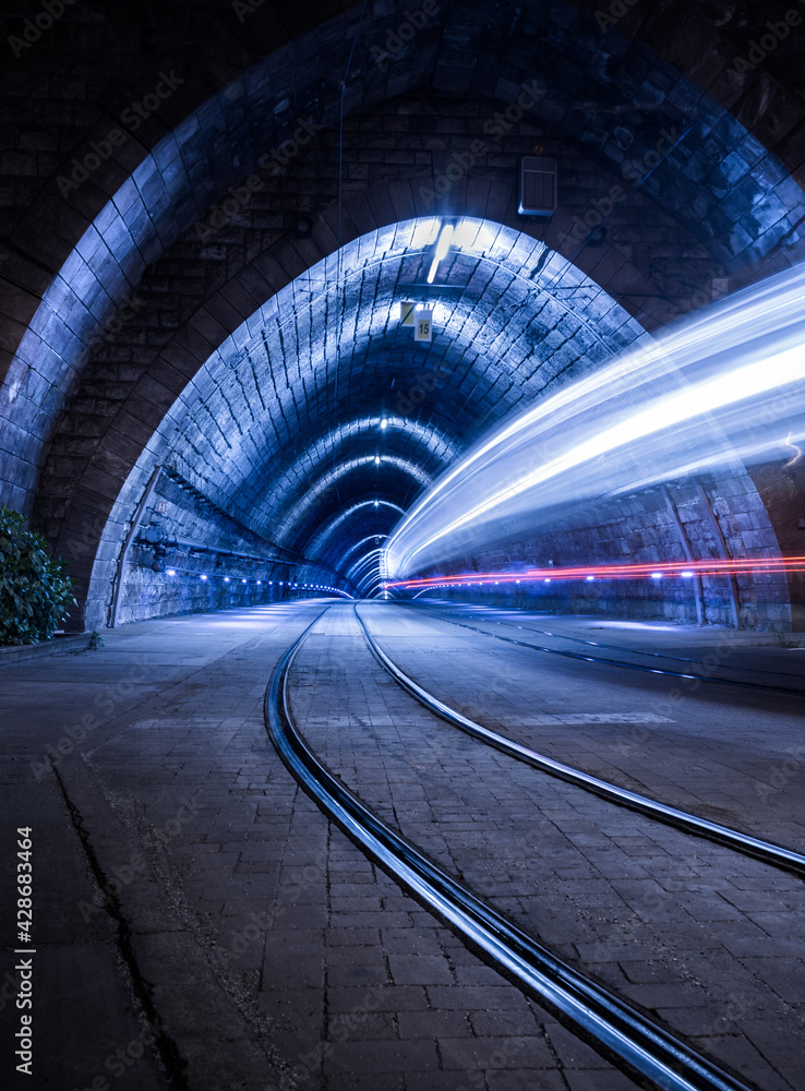 Illuminated Tramway Tunnel with Tram Light Trails at Night in Bratislava, Slovakia