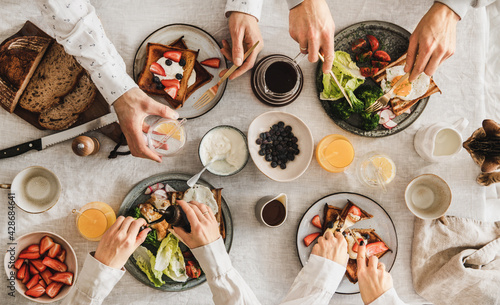 Family or friends having breakfast or brunch together, top view