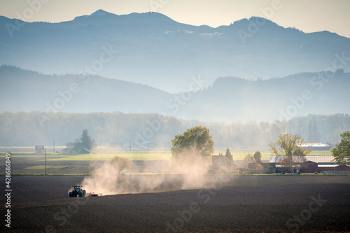 Farm Tractor Plowing a Field to Prepare for Planting. Springtime means a new season for planting crops and tilling the soil.