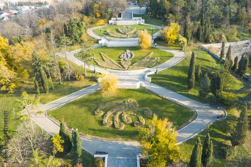 Malakhov kurgan, central entrance from above. Central staircase to the mound. The bright sun illuminates the colorful trees.