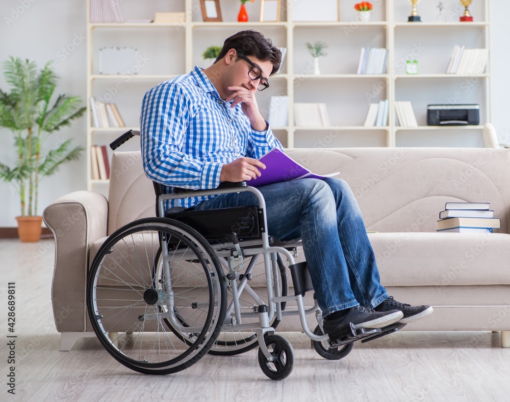Young student on wheelchair in disability concept Young student on wheelchair in disability concept