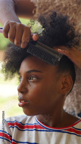 Young black girl getting hair done