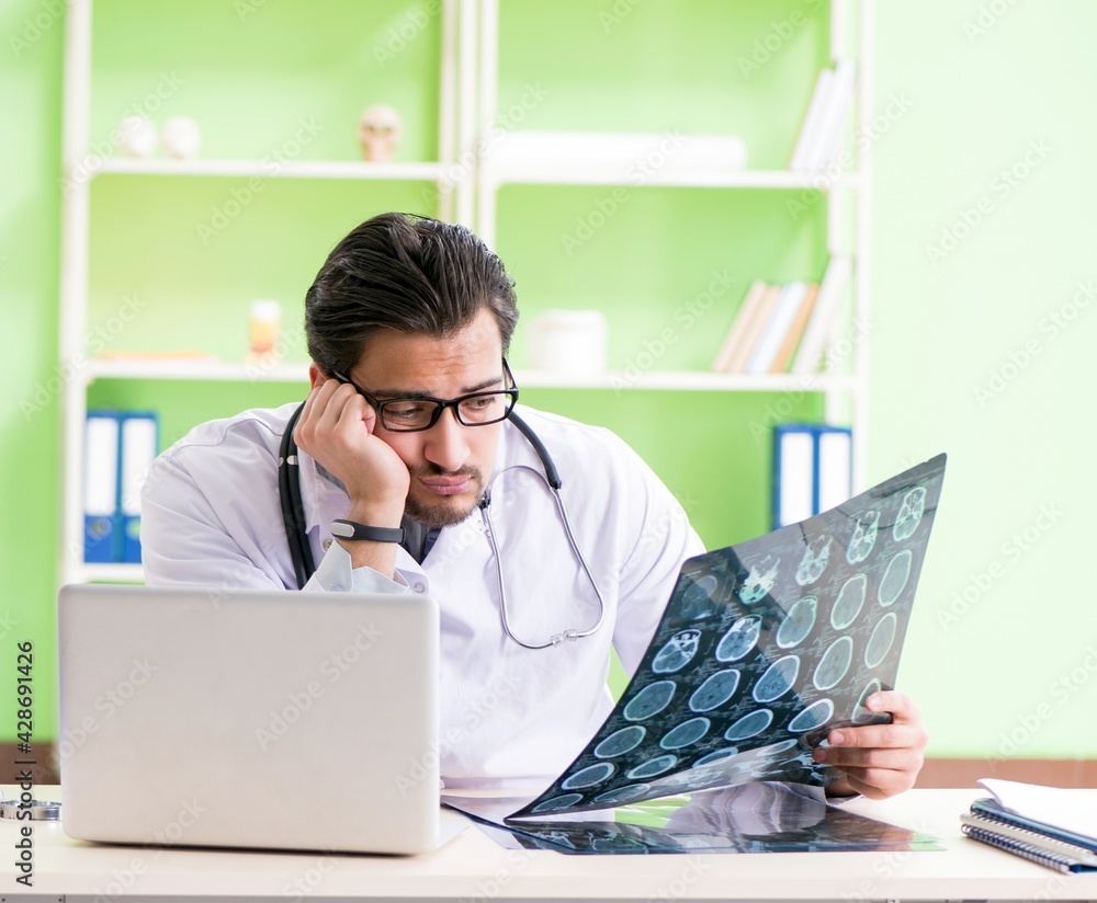 Doctor radiologist looking at x-ray scan in hospital Doctor radiologist looking at x-ray scan in hospital