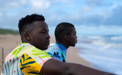 Young black men looking at the ocean © Cole Ndelu