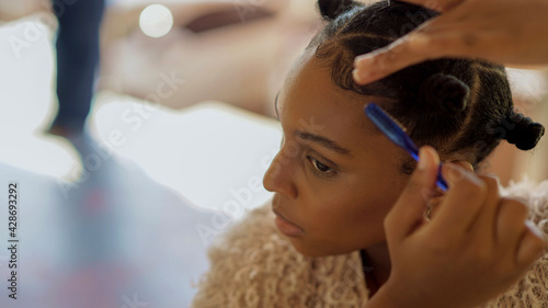profile of beautiful young woman with bantu knots laying her edges down photo