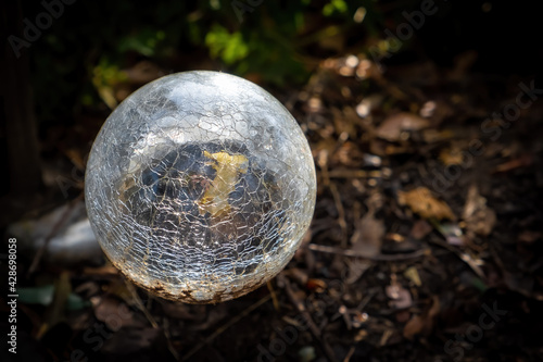 Garden light sphere broken glass on blurred background with copy space