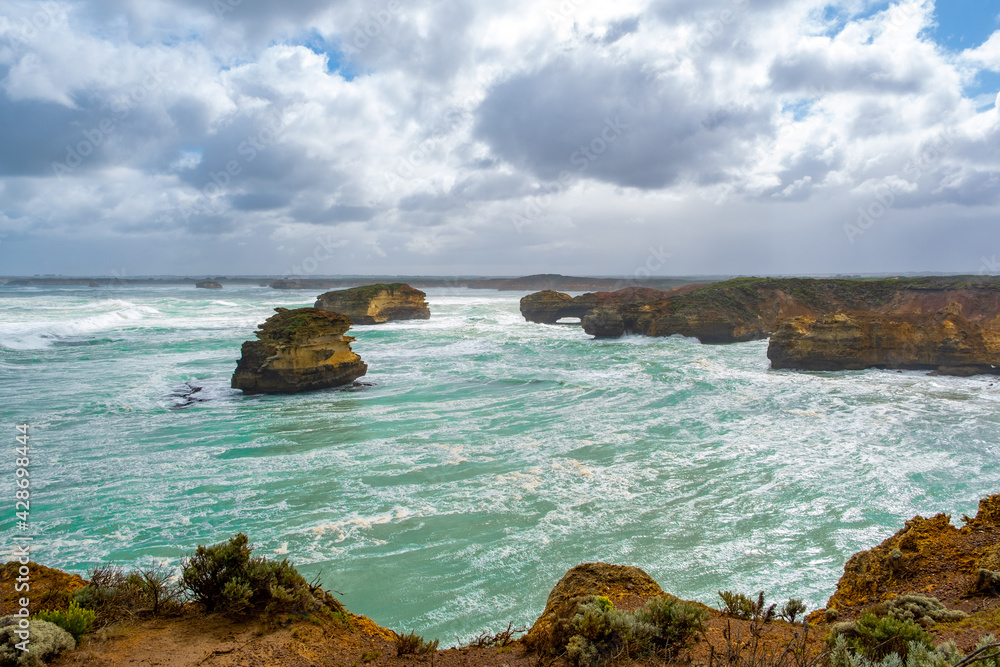 Fototapeta premium Beautiful ancient rock formations with breaking waves on the Great Ocean Road, Victoria, Australia