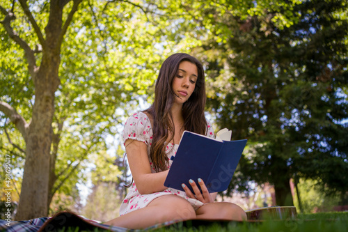 Beautiful Latina Singer Songwriter writing music in the park