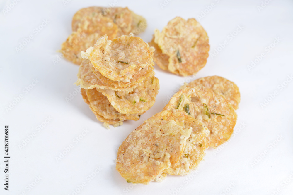Keripik tempe , tempeh crackers in a plate. Indonesian traditional snack. White background Stock