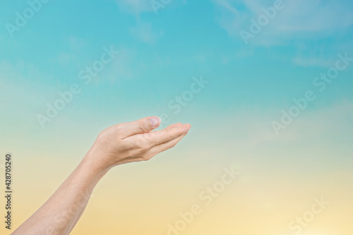 Human hands reaching for the sky sunset background. Hope concept