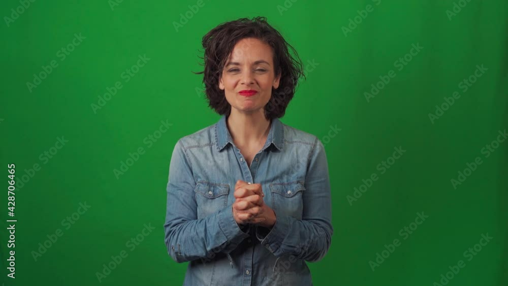 Caucasian woman on green chroma background, with very marked gestures. Very happy, congratulating and saying ok to the camera. Caucasian woman on green chroma background, with very marked gestures. Very happy, congratulating and saying ok to the camera.
