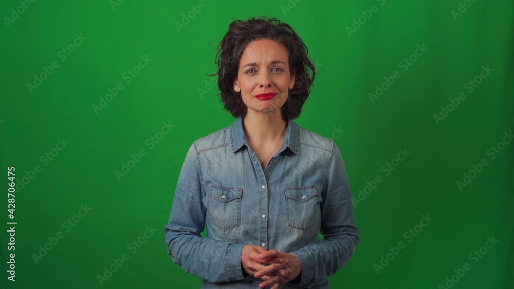 Caucasian woman on a green chroma background, with very marked gestures. Expressing much sadness at an apparent bad news. Crying and with sorrow. Caucasian woman on a green chroma background, with very marked gestures. Expressing much sadness at an apparent bad news. Crying and with sorrow.