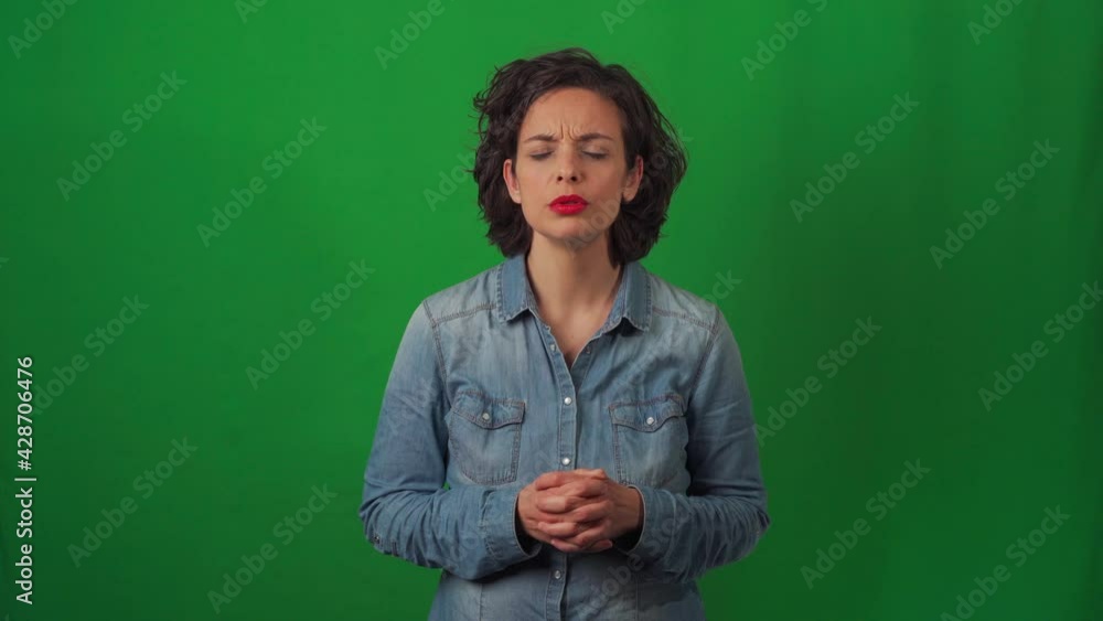 Caucasian woman on a green chroma background, with very marked gestures. Disappointed and sad. Apparently after a news item. Caucasian woman on a green chroma background, with very marked gestures. Disappointed and sad. Apparently after a news item.