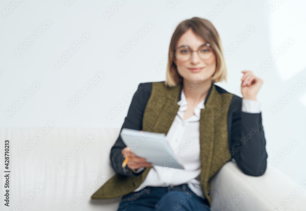 Business woman with documents and in a fashionable jacket on a light background Business woman with documents and in a fashionable jacket on a light background