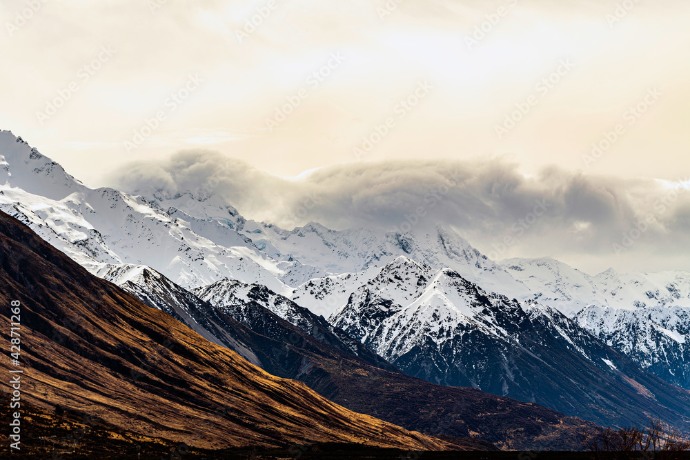Great rocky mountains, snowy mountains in winter and beautiful clouds in the morning. At Mount Cook National Park, South Island, New Zealand Suitable for use as a background or as a backdrop.