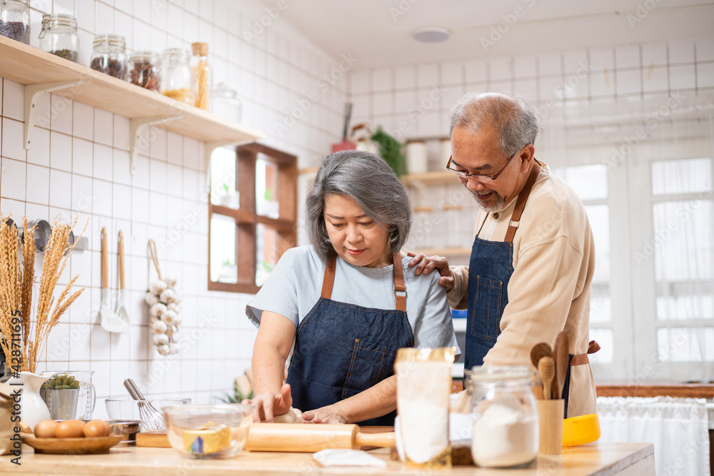 Asian senior couple helping each other for homemade bakery cooking. Asian senior couple helping each other for homemade bakery cooking.