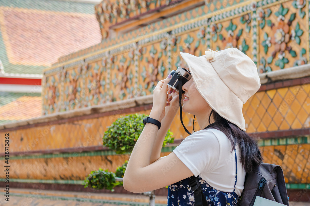 Traveler, travel young asian woman or girl use camera take photo at pagoda temple, city tourism, happy on sunny day..Guide backpacker tourist, holiday trip,summer or vacation, hobby concept.