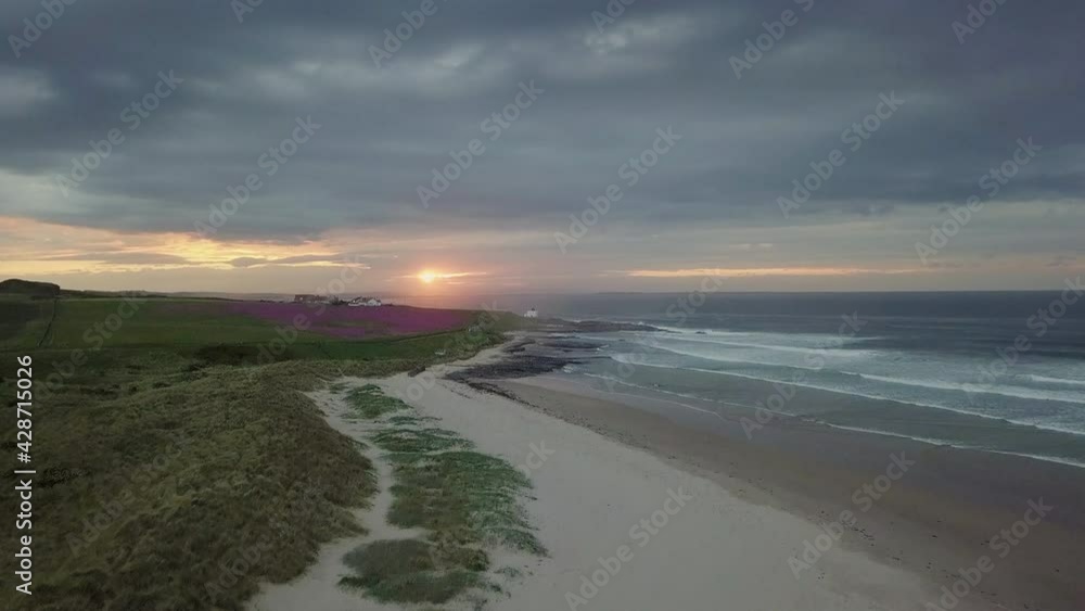 Aerial shot of the Bamburgh lighthouse in Northumberland during a sunset. Aerial shot of the Bamburgh lighthouse in Northumberland during a sunset.