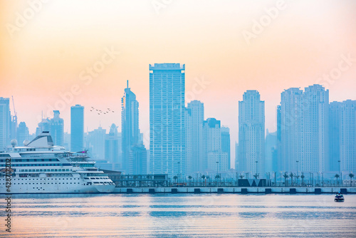 Morning of Dubai marina at sunrise with cruise ship  UAE