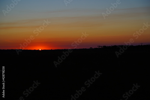 Sunset with orange and light blue sky © galexia