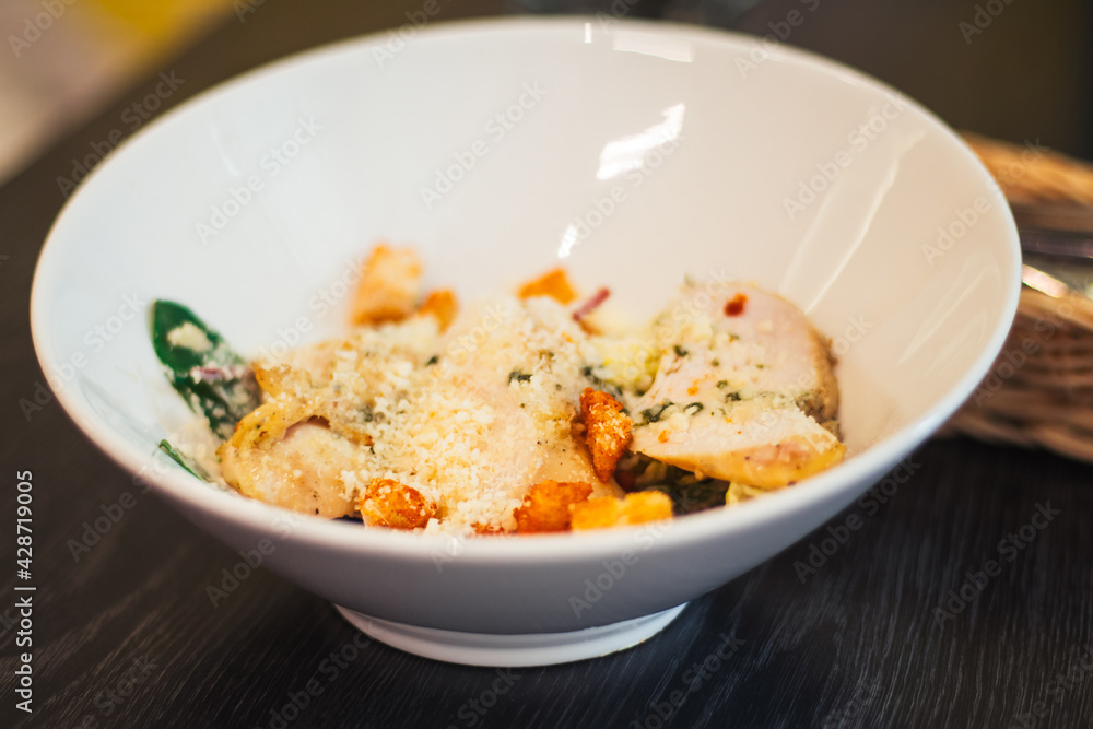 Children's portion of Caesar salad, in white deep plate Children's portion of Caesar salad, in white deep plate