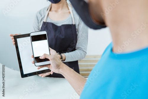 close up young female shopkeeper serve customer qr barcode online payment photo