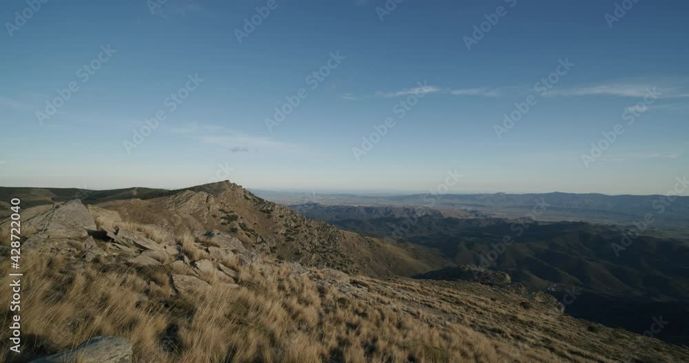 Cinematic pan shot gigantic landscape with rocks and mountains during blue sky and sunlight. Velefique,Spain. Cinematic pan shot gigantic landscape with rocks and mountains during blue sky and sunlight. Velefique,Spain.