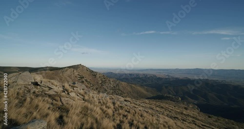 Cinematic pan shot gigantic landscape with rocks and mountains during blue sky and sunlight. Velefique,Spain. photo