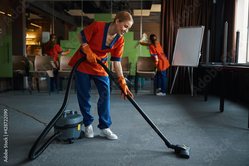 Janitorial staff tidying up the conference room