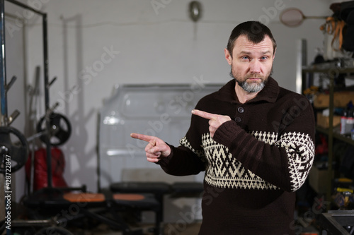 Photo of adult caucasian man in workshop shows fingers with emotions