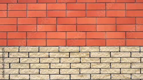 brick wall of two different types of material full frame, textured combined background of brickwork with copy space, two-color block backdrop of even masonry