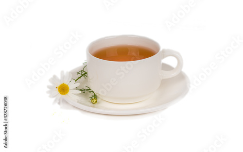 herbal chamomile tea in white porcelain cup on white background