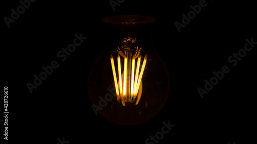 Lighting decor. Retro light bulb. Old dirty lamp dimly lit for Halloween. Selective focus. 