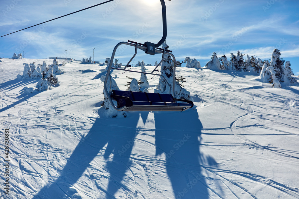 Empty ski chair lift on a mountain - season with no tourists.