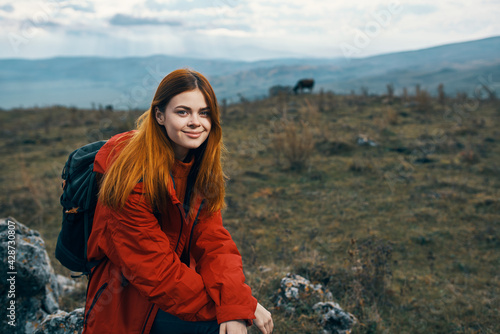 beautiful traveler with a backpack are resting in the mountains on nature landscape autumn © SHOTPRIME STUDIO