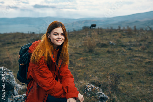 beautiful traveler with a backpack are resting in the mountains on nature landscape autumn