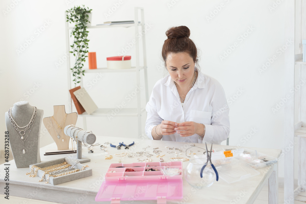 Professional accessories designer making handmade jewelry in studio workshop. Fashion, creativity and handmade concept. Professional accessories designer making handmade jewelry in studio workshop. Fashion, creativity and handmade concept.