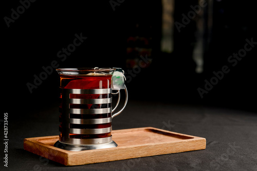 Tea mug over black background. Tea time close up photo