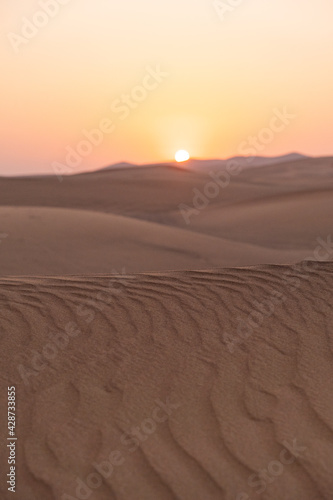 Landscape of desert dunes at sunset