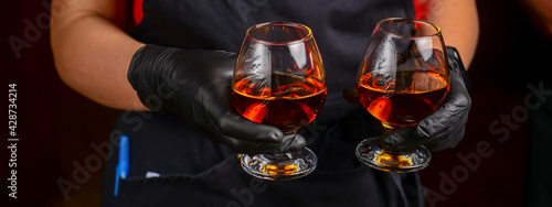 Εκτύπωση καμβά Closeup of a waiter holding two glasses of cognac