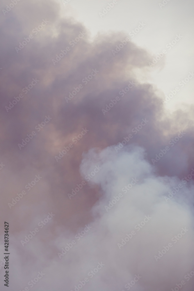 Swirling smoke from a large fire, similar to clouds. Cumulus clouds. Swirling smoke from a large fire, similar to clouds. Cumulus clouds.