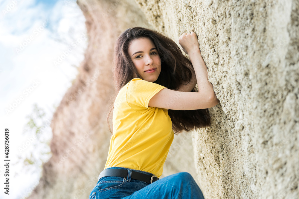 portrait of beautiful lady near wall of sand in canyon. lifestyle portrait of beautiful lady near wall of sand in canyon. lifestyle