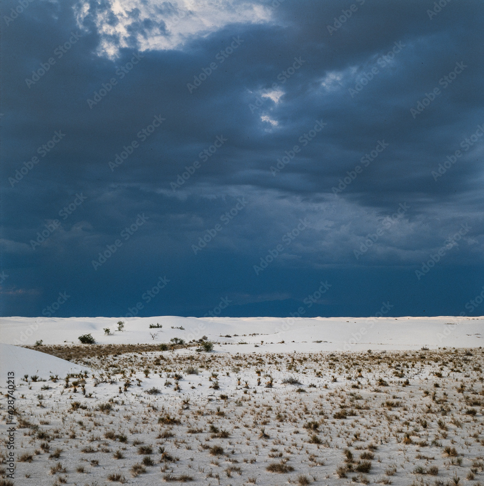 Desert. Sunset at twilight and heavy clouds. White Sands National Park American national park New Mexico USA. White Sands Missile Range. Tularosa Basin. White sand dunes composed of gypsum cryst