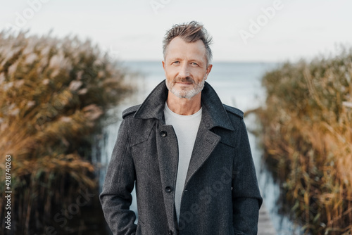 Obraz na plátně Quiet thoughtful man looking intently at the camera outdoors in nature