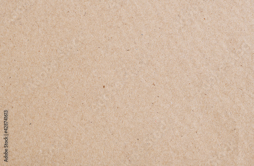 Texture of old organic cardboard, beige paper, background for design, copy space. Recyclable material, has inclusions of cellulose