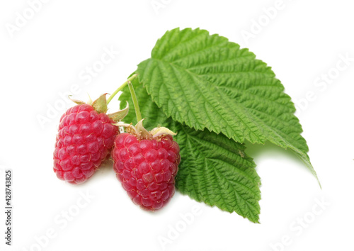 Two red ripe raspberries with green leaves isolated on a white background. Vitamins. Healthy vegetarian food.