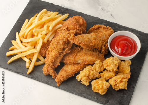 French fries and chicken nuggets and strips meal