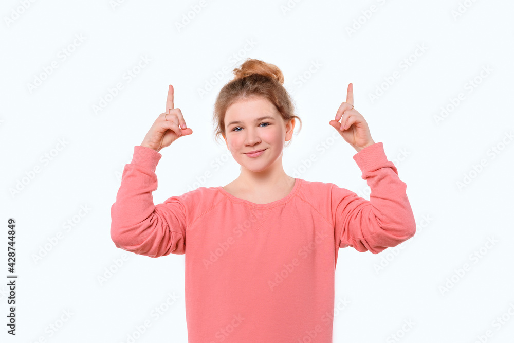 Attractive young girl pointing fingers up, showing good shopping site, recommend click link, upload app or subscribe Attractive young girl pointing fingers up, showing good shopping site, recommend click link, upload app or subscribe